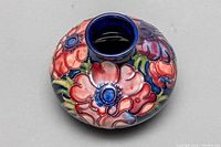 Top down view showing floral design and narrow opening of ceramic bud vase