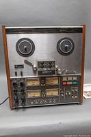 Front view of TEAC A-2340SX tape deck showing reels, control panel and wooden side panels