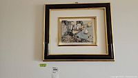 Framed Italian 3D metal relief art hung on wall showing entire piece including outer black and gold frame and white matte borders