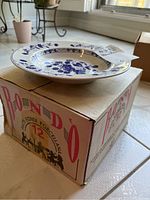 Soup bowl atop original box showing the box marked 'Rondò' porcelain from Italy, indicating 12 pieces.