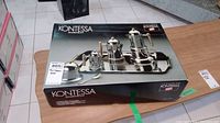 Box packaging of Kontessa coffee set showing product arrangement on tray with gold-tone accents