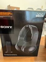 Front view of original product box showing Sony wireless headphone system with transmitter graphic.