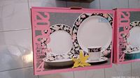 Box for Regent China 20-piece fine china dinner set with floral border design, includes dinner plates, salad plates, cups, saucers, and bowls, 4 place settings.