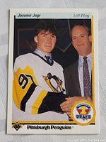 Front side of the 1990 Upper Deck Jaromir Jagr rookie hockey card showing Jagr in his Penguins jersey with draft designation and Upper Deck logo.