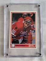 Front view of Eric Lindros hockey card in red Oshawa Generals jersey, held in a clear plastic case.