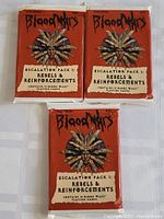 Three unopened sealed packs of Blood Wars Escalation Pack I: Rebels & Reinforcements shown from the front.