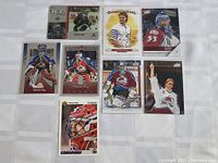 Full view of all nine Patrick Roy hockey cards laid out on a white surface.