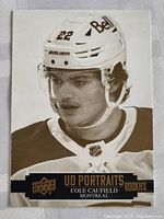 Front of Upper Deck Cole Caufield rookie card showing player portrait in Canadiens uniform.