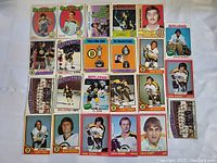 Top view of vintage Boston Bruins hockey cards laid out in a grid, showing player portraits, group shots, and commemorative cards.