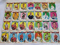 Photo showing 36 vintage hockey cards arranged in rows, displaying various NHL players from multiple teams with colorful backgrounds and player portraits.