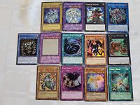 All 12 Yu-Gi-Oh! cards laid out on a surface showing front artwork and names.
