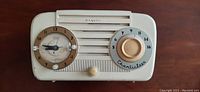 Front view of the white RCA Victor radio showing dials and speaker grille.