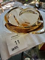 Top view of amber glass bowl showing thick rounded edges and glossy finish.