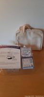 Dr. Ho Pain Therapy System control unit with instruction paper and makeup bag in background.