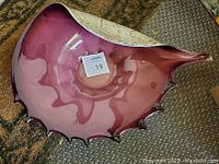 Top angled view showing purple inside and natural exterior resembling a conch shell.