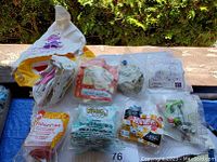 Vintage unopened McDonald's toys laid out on a table. Includes inflatable toys and plastic toy cars in original packaging.