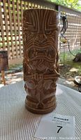 Full view of tall brown ceramic mug with tiki style carving representing Chewbacca, showing detailed facial and body design.