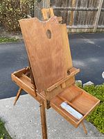 Front angle showing open compartments and artist's board with thumb hole