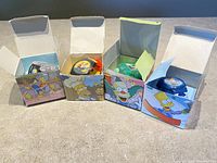 Four boxed Burgers King collectible Simpsons talking watches featuring various characters with colorful design artwork on boxes and watches.