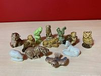 Photo showing all twelve Wade Red Rose Tea American Series ceramic animal figurines arranged against a red background.