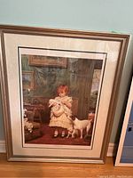 Full view of the framed print showing the girl and dogs in an indoor setting.