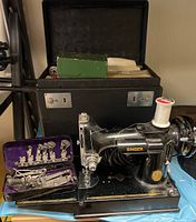 Top view of sewing machine in carry case with coiled power cord and accessories