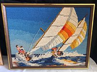 Full frontal view of framed tapestry showing windsurfing scene