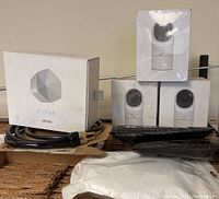 Overview of lot showing xFi Pods box, four individual G3 Flex cameras boxes, and cables with packaging materials.