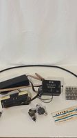 Overview showing Alpina calculator, Halda Tripmaster, spare gears, adapters, cable and instruction booklet