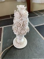 White porcelain floral night light lamp showing the detailed relief flower design on the body and base