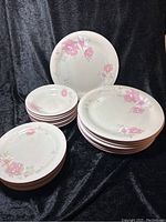 Overall view of the stacked plates and bowls showing quantity and pattern