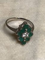 Top view showing clear center stone and surrounding green stones