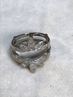 Two white gold stacking rings front view on light cloth background