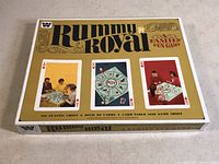 Top view of the Rummy Royal board game box showing the vintage design, images of players, and game details.