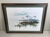 Front view of the framed waterfront landscape painting showing overall composition and frame condition.