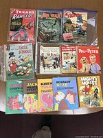 Vintage comic books and children's books with colorful illustrated covers showing minor to heavy wear and aging.
