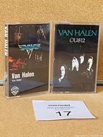 Front view of two Van Halen cassette tapes showing album artwork of Van Halen and OU812.