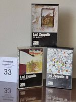 Front view of three Led Zeppelin cassette tapes in original cases showing album covers.