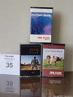 Front view of three Pink Floyd cassette tapes in their cases: Meddle, LPPE (Delicate Sound of Thunder), Atom Heart Mother