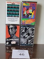 Front view of four Rolling Stones cassette tapes with covers visible.
