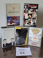 Front view of all five audio cassettes showing album artwork for Depeche Mode, Grand Funk, Pet Shop Boys, Sting, and Green Day.