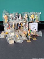 Full display of 26 vintage Canadian historical figurines with most individually bagged, 2 standing outside bags.