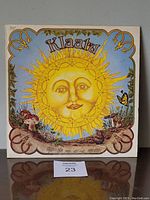 Front cover of 1976 Klaatu vinyl LP album, sun face artwork, colorful and whimsical design.