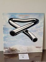 Front cover of 1973 Mike Oldfield Tubular Bells vinyl LP featuring tubular bells against sky and ocean background