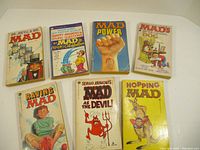 Photo of all 7 MAD books displayed in two rows showing front covers