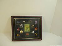Framed display case holding the complete collection of Stanley Cup winners pins with visible NHL team logos.