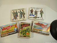 Photo showing three Tamiya Military Miniatures German Army Officer figure kits and three Matchbox model kits including Red Arrows, BAE Hawk 100 planes and a miniature soldiers pack.