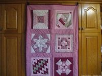 Front view of the quilt showing all six patchwork blocks with distinct patterns and colors.