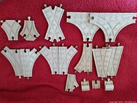 White plastic Thomas the Train track connectors in various shapes. Includes switch rail tracks, curved tracks, buffers, ramp pieces.