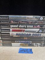 Stacked PS2 game cases with visible titles including Medal of Honor Frontline, Sea of Destruction, Grand Theft Auto Vice City, Burnout 3 Takedown, NASCAR 2001, The Mummy, Extermination, and Getaway.